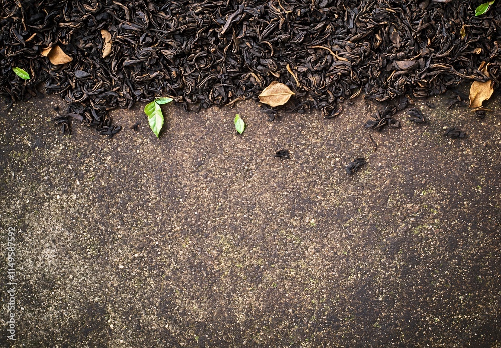Obraz premium Dried Tea Leaves on Rough Stone Surface Background