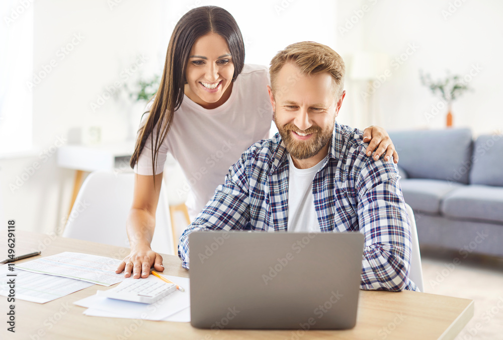 Family couple manages bills, payments, and debt at home using a laptop. Working together on financial tasks, handling accounting, highlighting teamwork in managing household expenses. Family couple manages bills, payments, and debt at home using a laptop. Working together on financial tasks, handling accounting, highlighting teamwork in managing household expenses.