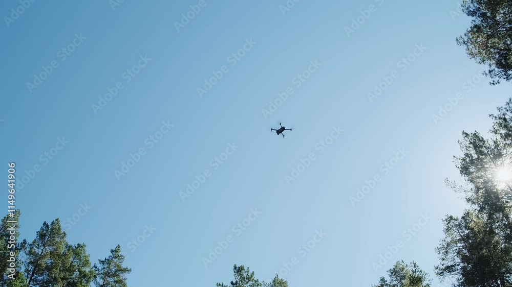 Drone flies over the trees shoots video. Aerial photography equipment. Quadcopter with camera flying over the woods in the sky. Drone flies over the trees shoots video. Aerial photography equipment. Quadcopter with camera flying over the woods in the sky.