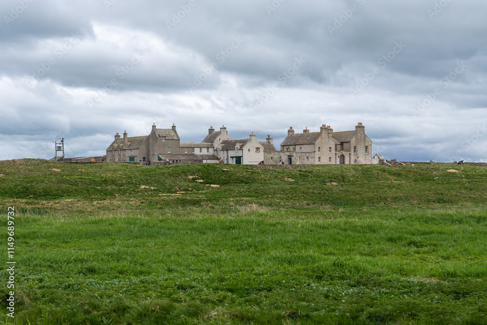 Historic Skaill House on Orkney surrounded by green meadows and cloudy skies Historic Skaill House on Orkney surrounded by green meadows and cloudy skies