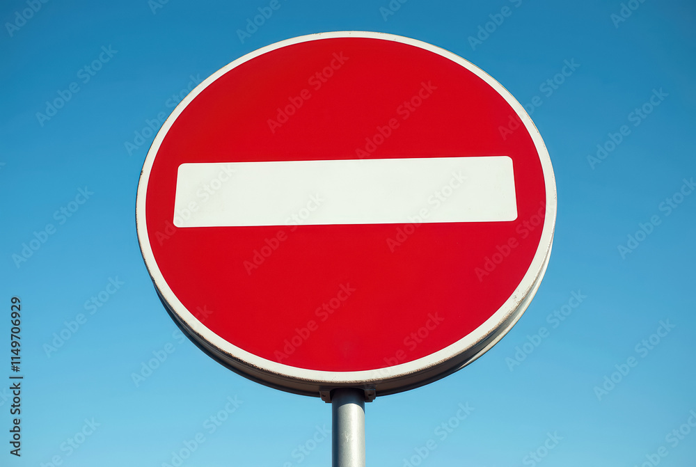 Red and white prohibition sign against a blue sky Red and white prohibition sign against a blue sky