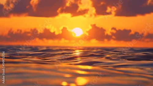 A serene sunset over the ocean, reflecting vibrant colors on the water's surface.