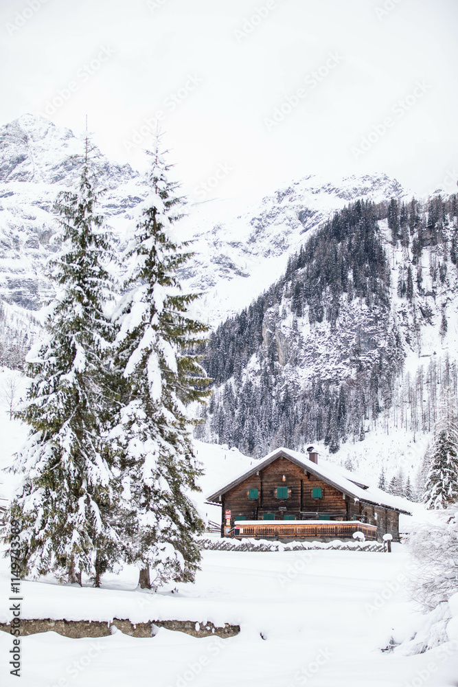 a wooden house in the snow covered scenery, a true winter wonderland with the mountains in the background a wooden house in the snow covered scenery, a true winter wonderland with the mountains in the background