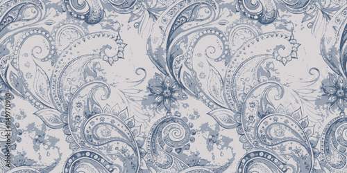 Elegant blue paisley pattern with floral accents on a soft background.