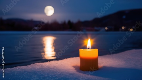 There is a lighted candle in the snow by the water. The moonlight path is reflected in the water. Cozy and quiet atmosphere. A photo with a place for the text. photo