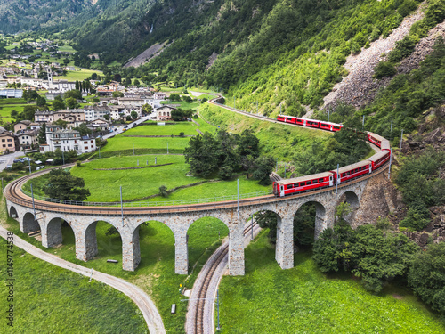 Aerial view of a Bernina Express train crossing the Brusio spiral viaduct, Grisons canton, Switzerland