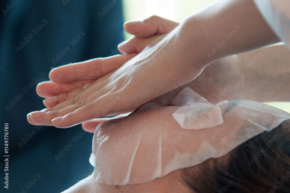 Naklejka premium Woman lying on couch at beautician, antiaging cosmetic facial treatment