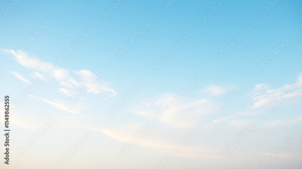 Obraz premium Serene Pastel Sky Delicate wisps of clouds drift across a pale blue expanse.