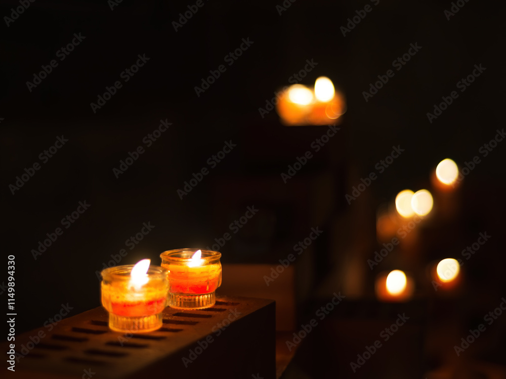 Close-up of illuminated candles on table Close-up of illuminated candles on table