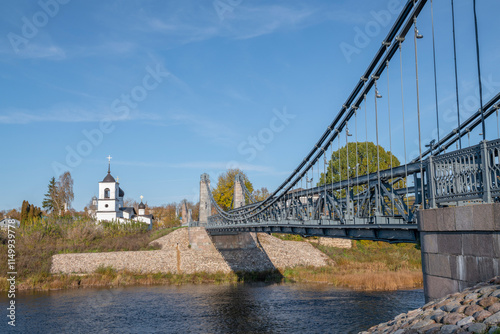 At the ancient suspension chain bridge on a sunny October day. Ostrov, Pskov oblast. Russia