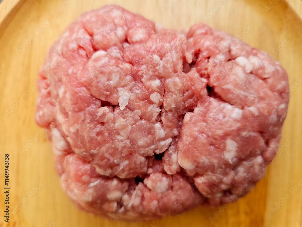 Closeup view. Minced pork on a wooden plate. Closeup view. Minced pork on a wooden plate.