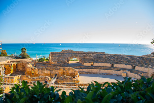 colossal roman ruins of historic theater in tarragona coastline with mediterranean sea of ​​spain on sunny day tourist spot in the city