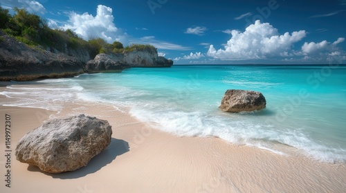 The rocky shoreline of a beach, with smooth, weathered stones dotting the sand,