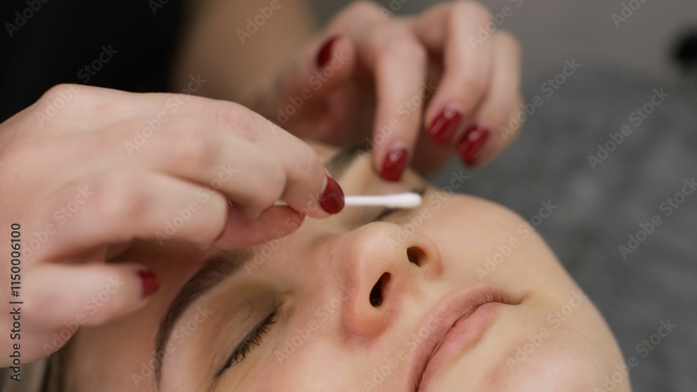 Preparing eyes for eyelash extensions, beauty salon. A woman is preparing for the eyelash extension procedure. Preparing eyes for eyelash extensions, beauty salon. A woman is preparing for the eyelash extension procedure.