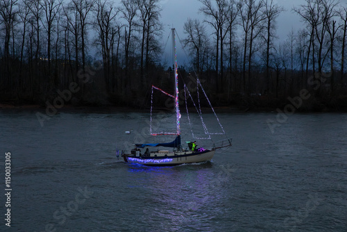 Portland, OR, USA - December 2024 - A scenic view of the illuminated ship parade on the Willamette River, celebrating the 70th anniversary of the event under a dramatic evening sky photo