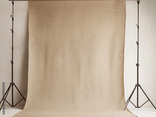 Minimalist Photography Studio Setup with Beige Backdrop and Lighting Stands