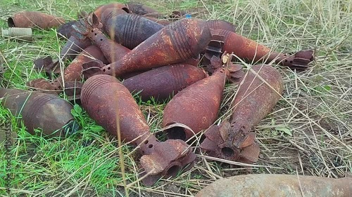 Burnt mortar shells lie on the ground. Mortar shells shattered by the explosion lie on the ground. High quality