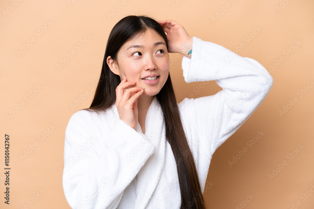 Young Chinese woman isolated on beige background . Portrait Young Chinese woman isolated on beige background . Portrait