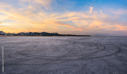Obraz na płótnie Asphalt road square and coastline with beautiful sky clouds nature landscape at sunset. Outdoor asphalt parking lot. w salonie