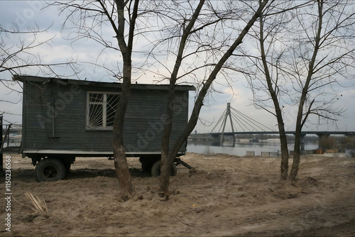 Vintage construction trailer on wheels in Obolon with view of Northern Bridge, Kyiv, Ukraine