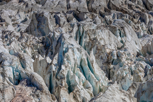 Glacier le Bossons in the french Alps, Chamonix valley, Montblanc. The glacier crevasse and huge serac with blue ice on slopes of Mont Blanc. Melting glacier caused by climate change global warming