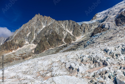 Glacier le Bossons in the french Alps, Chamonix valley, Montblanc. The glacier crevasse and huge serac with blue ice on slopes of Mont Blanc. Melting glacier caused by climate change global warming