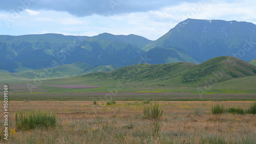 Mountains views of meadows and rivers on a summer cloudy day , Kazakhstan, Kegen, Aktas mount, Tekes river. photo