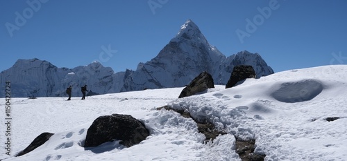 Amazing view on trekking through Kongma La Pass 5535 m, from Dingboche to Lobuche. Silhouettes of trekking persons on snow. Ama Dablam Mount in background. Everest Base Camp trek. Himalayas, Nepal photo