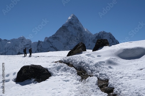 Amazing view on trekking through Kongma La Pass 5535 m, from Dingboche to Lobuche. Silhouettes of trekking persons on snow. Ama Dablam Mount in background. Everest Base Camp trek. Himalayas, Nepal photo