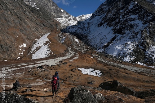 Group of trekking people on descent from Kongma La Pass 5535 m to Lobuche village. Everest Base Camp, Himalayas, Sagarmatha National Park, Nepal  photo