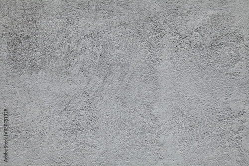 Grey wall texture, background. Decor of cement coating. Gray surface backdrop. Structural silicone plaster with grinding traces. Rough, uneven surface in grey color. Modern cladding of new buildings photo