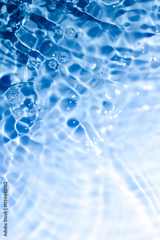 Close-up view of rippling water with vibrant blue tones and light reflections. Close-up view of rippling water with vibrant blue tones and light reflections.