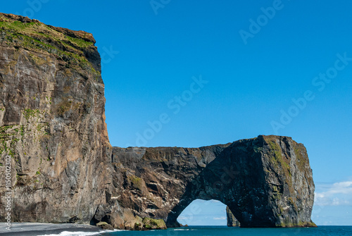 Dyrholaey, which is a small peninsula on the south coast of Iceland, is famous for its prominant and natural arch. It offers a great view of the black sand beaches around the village Vik. photo