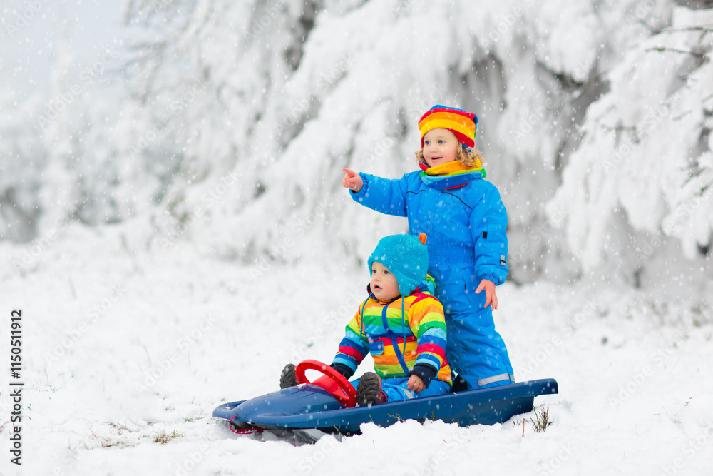 Kids play in snow in winter park Kids play in snow in winter park