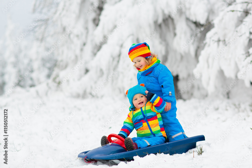 Kids play in snow in winter park Kids play in snow in winter park