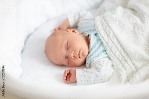 Cute newborn baby in white bed