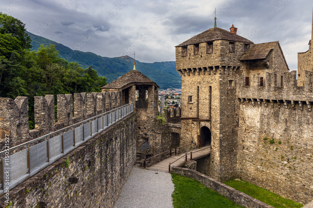 Obraz premium medieval castelgrande castle of bellinzona in switzerland. A castle with a stone wall and a stone staircase