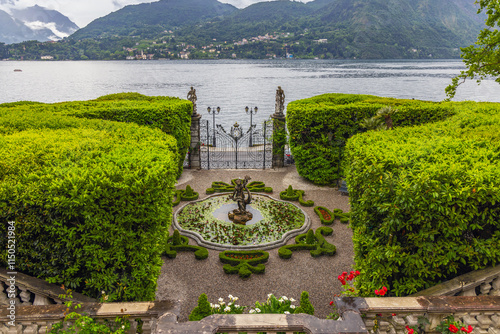 View from the palace to Lake Como and the entrance to the park in the gardens of Villa Melzi in Bellagio, Lake Como, Italy