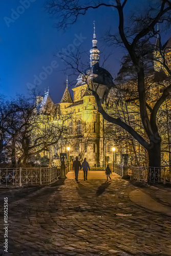 Budapest, Hungary, castle in the city park near Heroes' Square, evening hours, magical lighting, late-night strolling couple