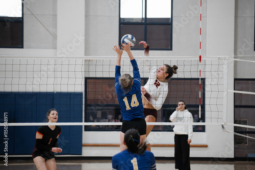 Volleyball player hitting cross around a single block