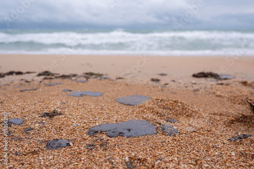 Fuel oil stains on the Black Sea coastline. Environmental disaster, environmental pollution. Oil spill photo