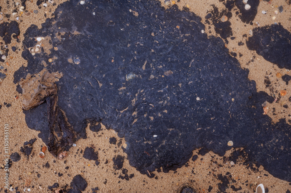 Fuel oil stains on the Black Sea coastline. Environmental disaster, environmental pollution. Oil spill Fuel oil stains on the Black Sea coastline. Environmental disaster, environmental pollution. Oil spill