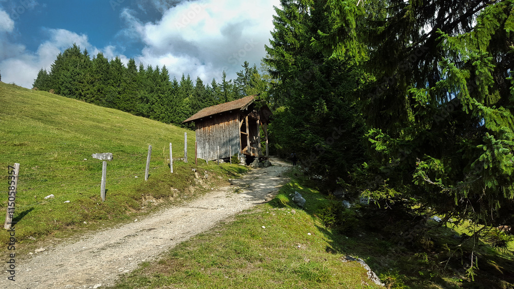 The way to the Wendelstein mountain in Bavaria. Mountains with forests, blue sky and sunshine.