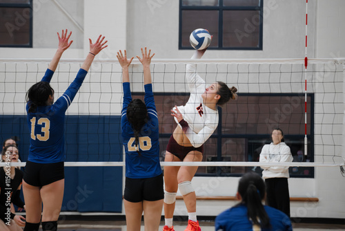 Volleyball outside hitter against a double block
