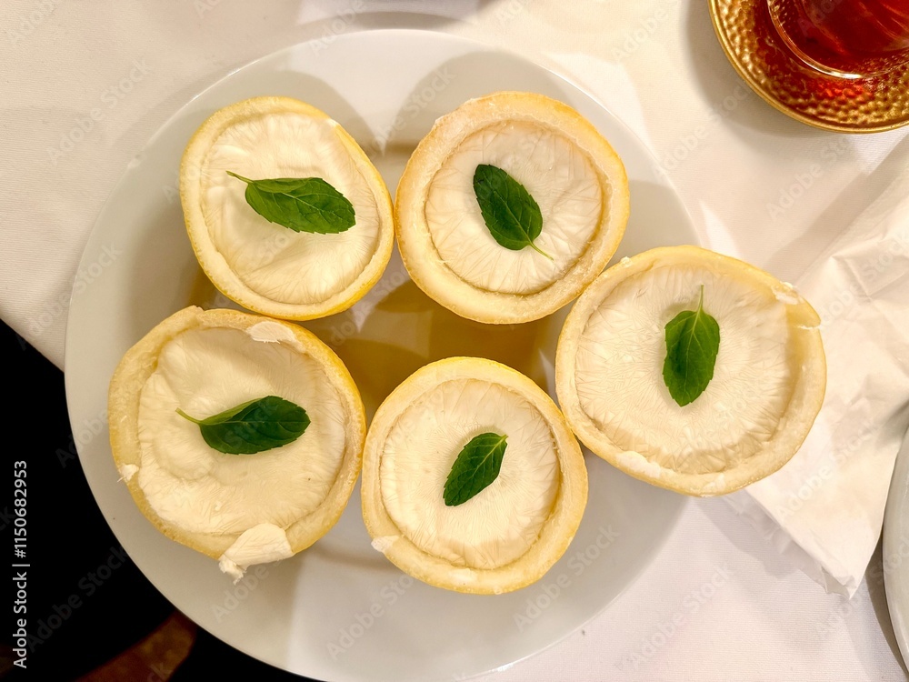 Lemon sorbet ice cream with peel served at plate Lemon sorbet ice cream with peel served at plate