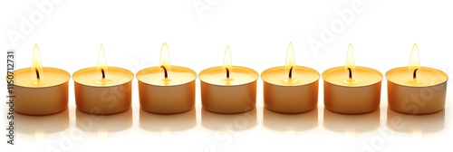 A serene arrangement of lit tealight candles glowing softly in a row.