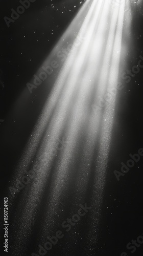 Light rays penetrate darkness creating a serene atmosphere underwater
