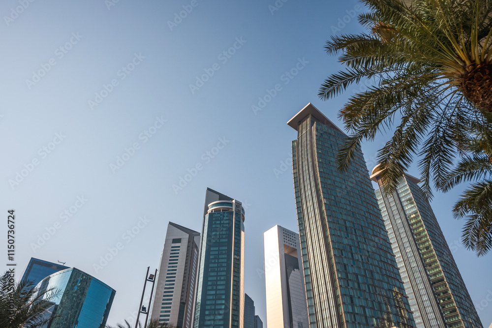 Bottom view of skyscrapers and tall buildings in Doha, Qatar with wide angle sky Bottom view of skyscrapers and tall buildings in Doha, Qatar with wide angle sky
