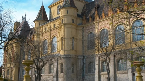 Spring time in budapest castle. A view of sunny spring view of vajdahunyad castle facade against sky in hungary. A concept of historical landmark in Budapest. photo