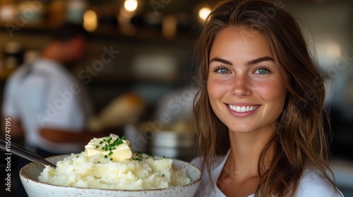Smiling woman serving creamy mashed potatoes in a cozy restaurant setting dur...